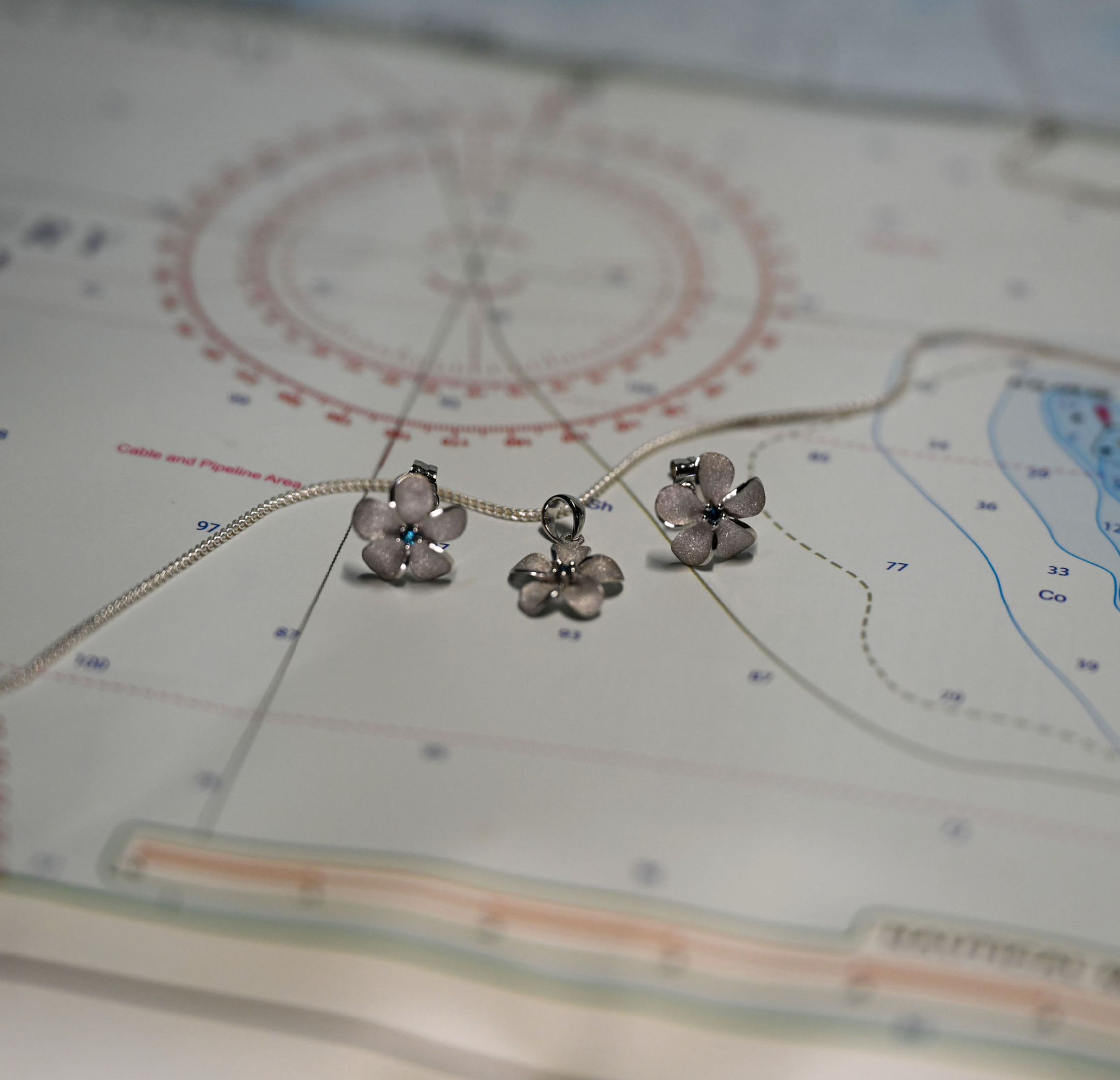 14kwg 11mm Plumeria Pendant w/blue diamonds (.02cttw)