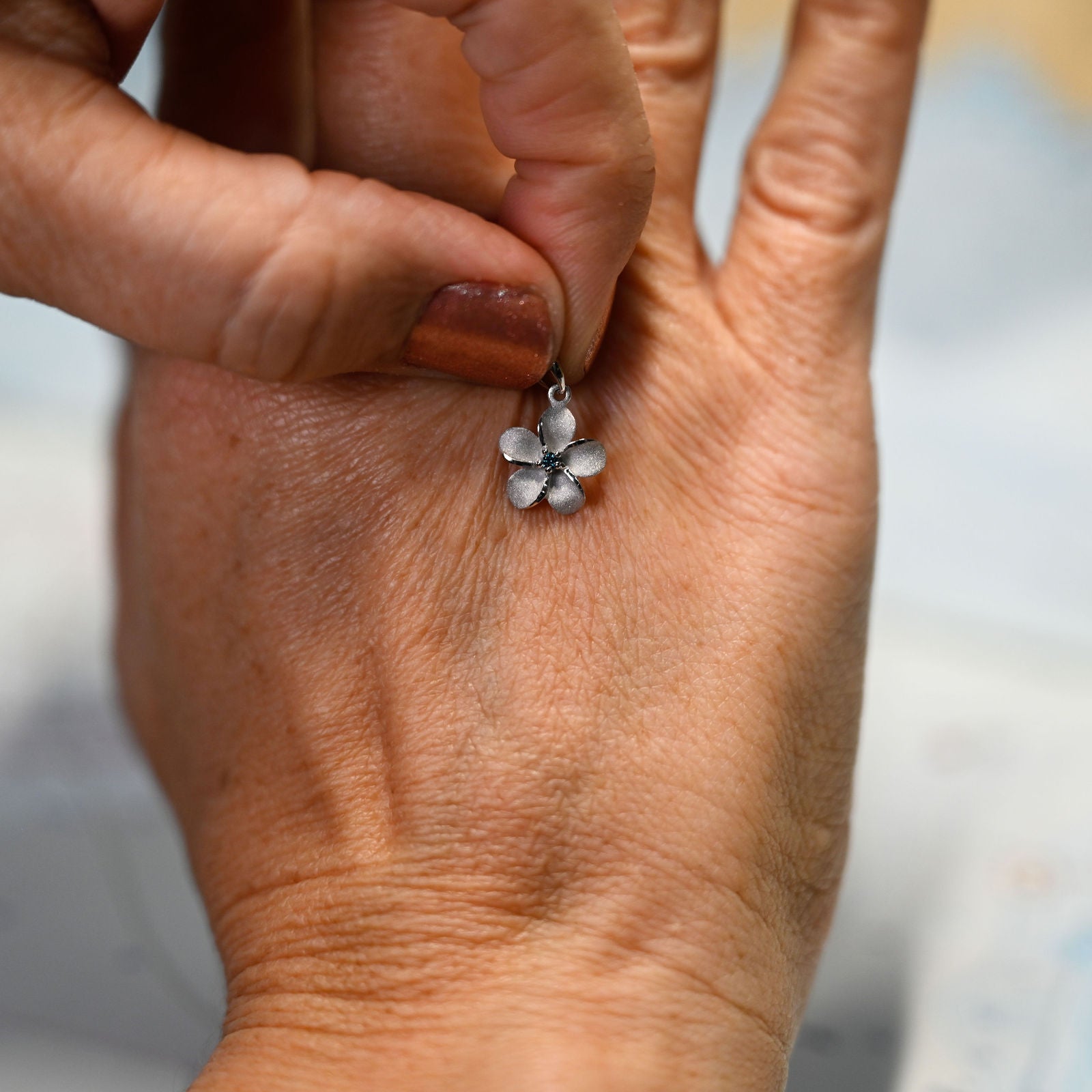 14kwg 11mm Plumeria Pendant w/blue diamonds (.02cttw)